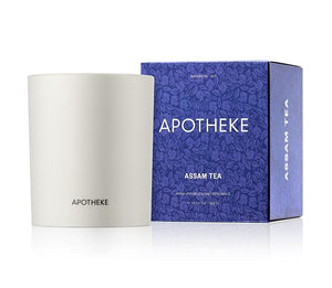 Apotheke Assam Tea 11oz candle in a jar with bluish purple box packaging next to it in front of white background.